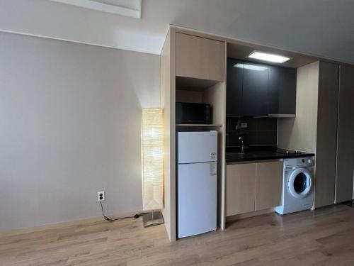 a small kitchen with a refrigerator and a microwave at FreeLuggageStorage 1Queen1SingleBed MilkyWay in Pyeongchang 