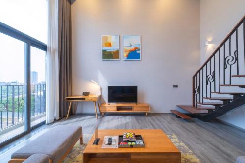 a living room with a couch and a tv at Luxury Pentstudio Westlake - Tay Ho, Ha Noi in Hanoi
