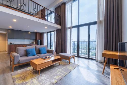 a living room with a couch and a table at Luxury Pentstudio Westlake - Tay Ho, Ha Noi in Hanoi