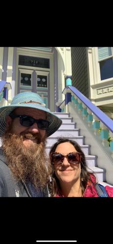 a man and a woman standing in front of a house at Grateful Dreams Lodging in Arcata