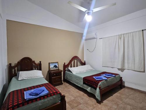 a bedroom with two beds and a ceiling fan at Finca Don Celestino in La Banda