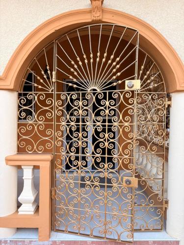 an ornate metal door with a gate on a building at White House by White River in Ocho Rios