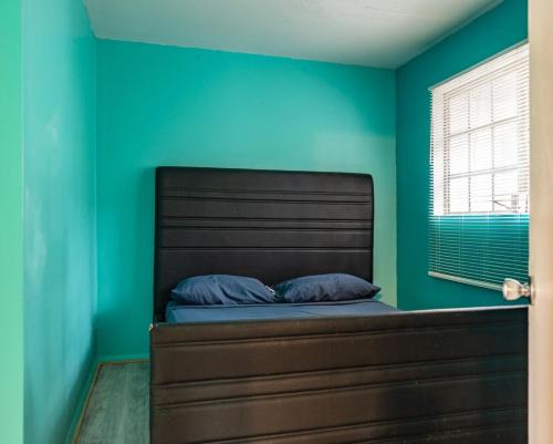 a bedroom with a bed with a blue wall at GpL 2668 one bedroom in Fort Myers