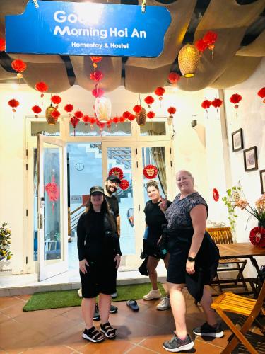 a group of people standing in front of a building at Good Morning Hoi An Homestay and Hostel in Hoi An