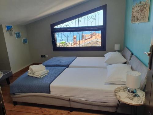 a bedroom with a large bed with a window at teo`s Apartment Nikiti in Nikiti