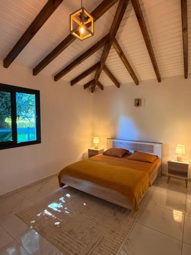 a bedroom with a large bed in a room at Villa Sheba in Lamentin