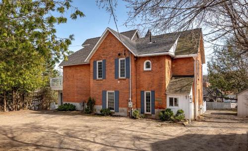 a brick house with a gambrel roof at Downtown Huntsville Gem in Muskoka in Huntsville