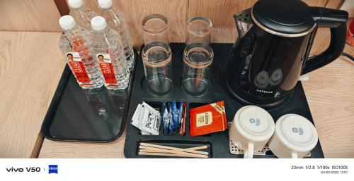 a tray with a coffee maker and other items on it at Hotel Mantavya in Kakarmatha