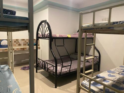 a bunk bed room with two bunk beds in it at Leonisa Transient House in Mariveles