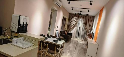 a living room with a kitchen and a living room with at Sunway Geo Suites CA0F at Sunway City by Ezprop in Subang Jaya