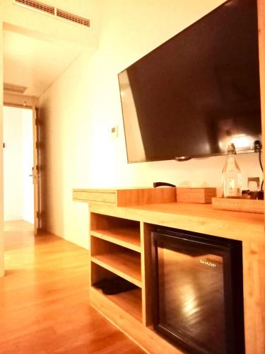 a living room with a large television on a counter at Truntum Boutique Mandalika in Kuta Lombok