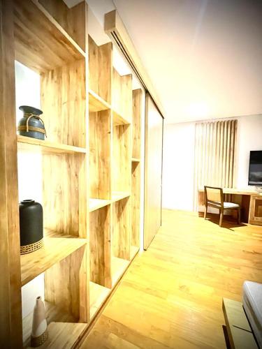 a living room with a wooden wall with shelves at Truntum Boutique Mandalika in Kuta Lombok