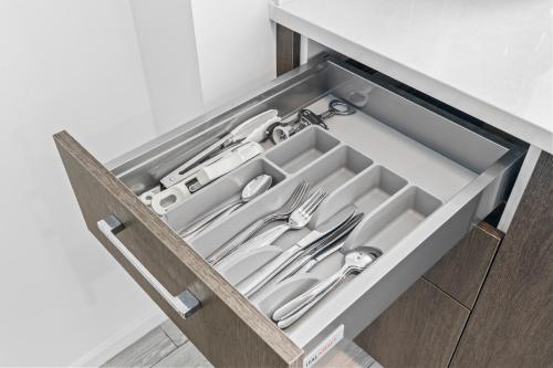a drawer with silver utensils in it at Luxury Suite Heated pool & jacuzzi in Miami