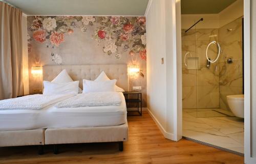a bedroom with a bed and a shower at Hotel Zehnthof in Cochem
