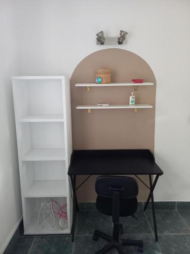 a desk and a chair in a room at Garden & Terrace Apartment in Noumea