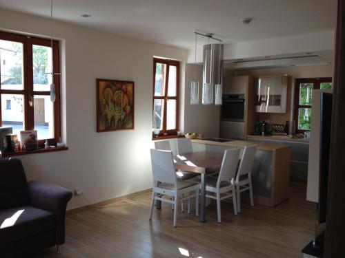 a kitchen with a table and chairs in a room at Luxusní Vinařská Villa in Pavlov