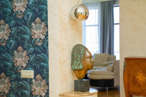 a room with aumedumed head on a table in front of a wall at Sunday Hotel & Apartments in Baku