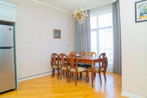 a dining room with a table and chairs at Sunday Hotel & Apartments in Baku
