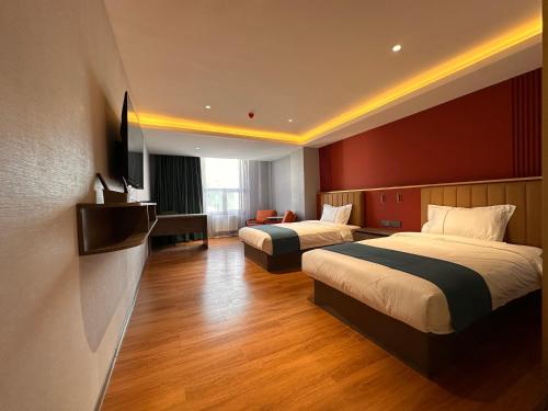 a hotel room with two beds and a television at Bojon Hotel Ulaanbaatar - Soyolj Mall in Ulaanbaatar