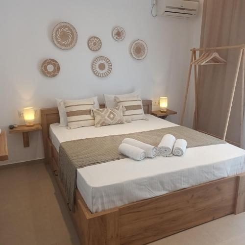 a bedroom with a large bed with towels on it at Maison Kalogiannis in Patitiri