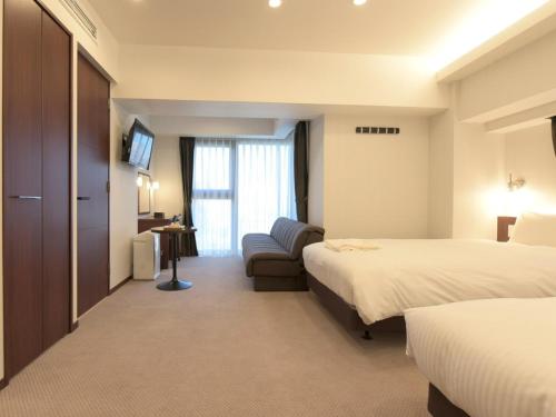 Postel nebo postele na pokoji v ubytování HOTEL BRILLIO ASAKUSABASHI