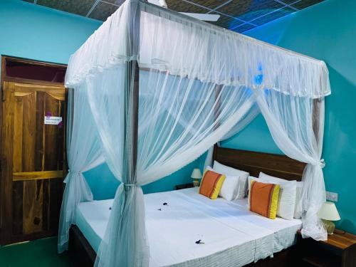 Postel nebo postele na pokoji v ubytování Sigiri Siesta Homestay