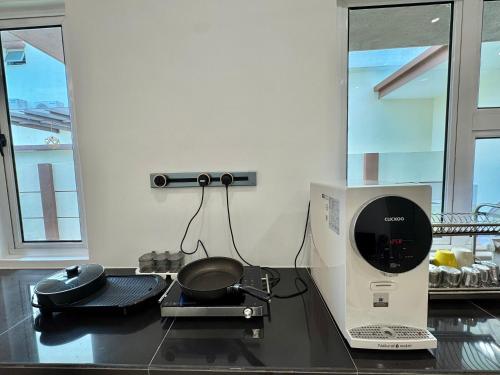 a kitchen with a pan on top of a counter at Heartstay Tanjong Karang 妍菁名宿 in Kampong Tanjong Karang