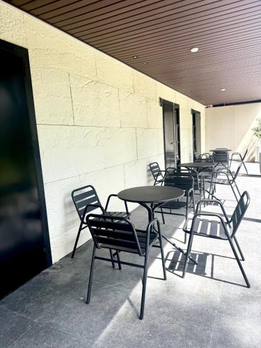 a row of tables and chairs on a patio at Your Brothers House Tribal Village in Legazpi