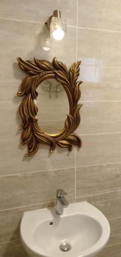a mirror on a wall above a sink in a bathroom at Blumar El Sokhna Chalet in Ain Sokhna