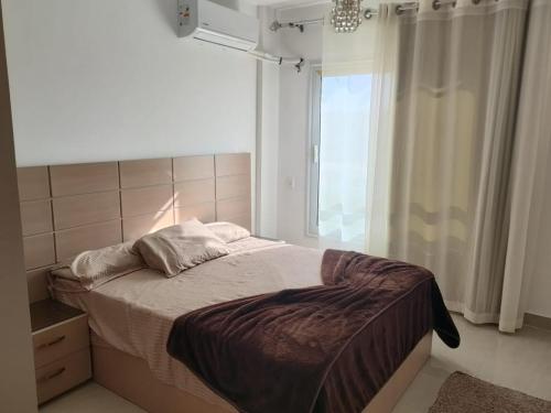 a bedroom with a large bed with a window at Blumar El Sokhna Chalet in Ain Sokhna
