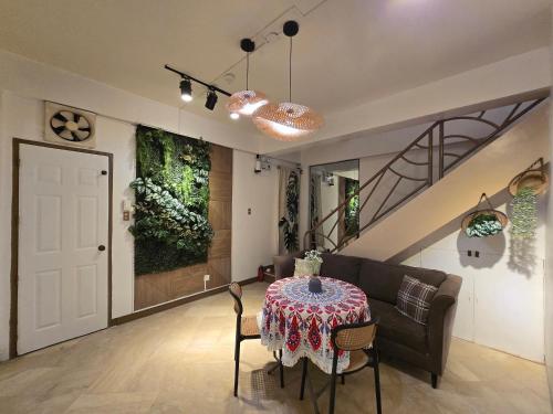 a living room with a table and a couch at Simoy Staycation Tagaytay in Tagaytay