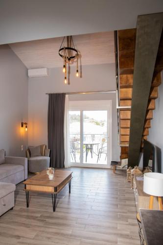 a living room with a couch and a table at Vot villas in Ormos Panagias