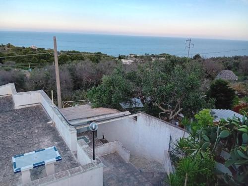 a view of the ocean from the roof of a house at Dimora ideale SALENTO3 per coppia vista mare mozzafiato immersa nel verde per gli amanti della tranquilità in Alessano