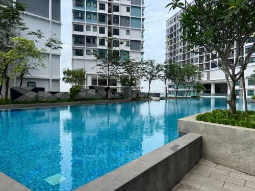 a swimming pool in a building with tall buildings at HYDE1 i-City ITQAN Premium Home - 8pax, Netflix, Parking in Shah Alam