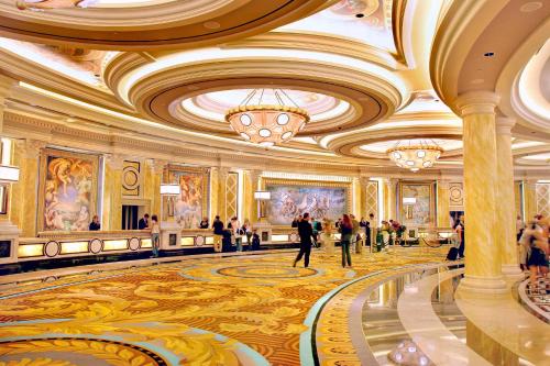 a lobby of a hotel with people walking in it at Caesars Palace Hotel & Casino in Las Vegas