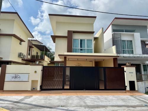 a house with a gate in front of it at Heartstay Tanjong Karang 妍菁名宿 in Kampong Tanjong Karang