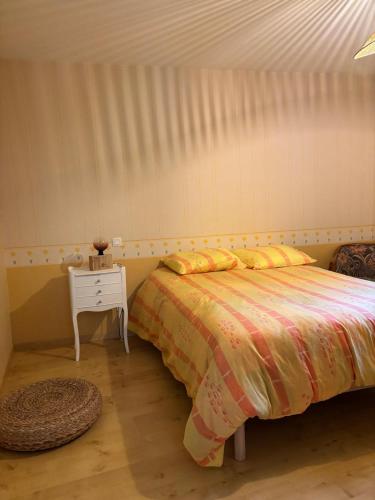 - une chambre avec un lit et une table avec une table de chevet dans l'établissement la maison de la Felicidad, à Boussy