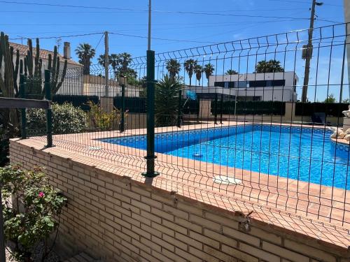 a swimming pool with a fence around it at River Dreams in Deltebre