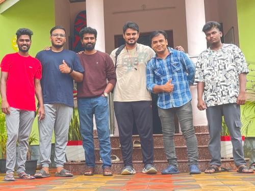 a group of men standing in front of a building at SEVENSTAR RESIDENCY in Varkala