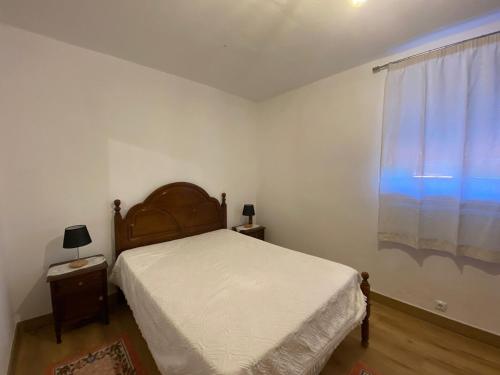 a small bedroom with a bed and a window at Casa Museu da Avó Gena in Mazouco