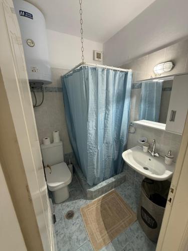 a small bathroom with a toilet and a sink at Sea view apartment in Paralion astros