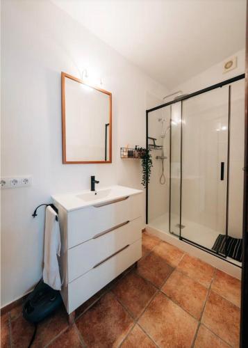 a bathroom with a sink and a shower at Cases Tonet Apartamento-loft in Forcall