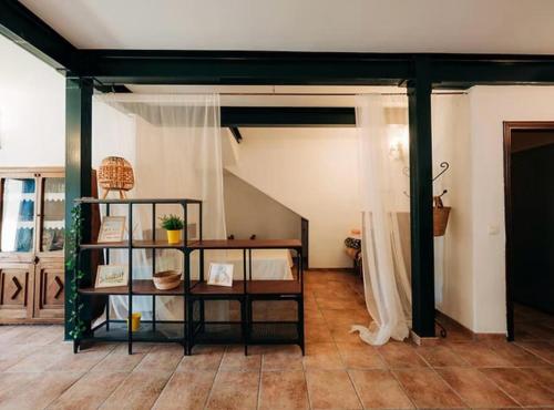 a living room with a table and a staircase at Cases Tonet Apartamento-loft in Forcall