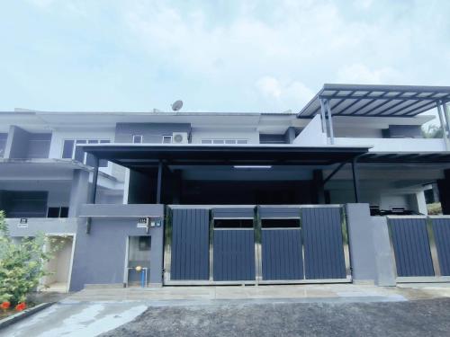 a house with a gate in front of it at Serena Villa Mslim Only With Indoor Private Pool in Port Dickson