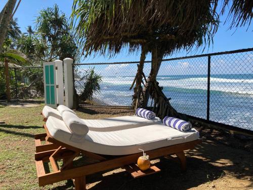 a hammock with a view of the ocean at Reef House in Kamburugamuwa
