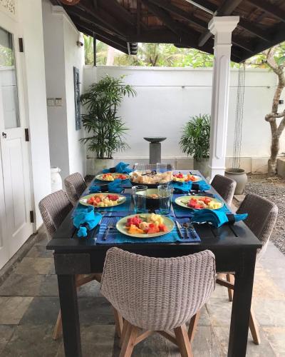 a black table with plates of food on it at Reef House in Kamburugamuwa