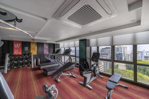 a gym with treadmills and elliptical machines at Jen Maldives Male by Shangri-La in Male City