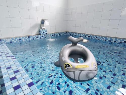 a bathroom with a inflatable whale in a pool of water at Serena Villa Mslim Only With Indoor Private Pool in Port Dickson