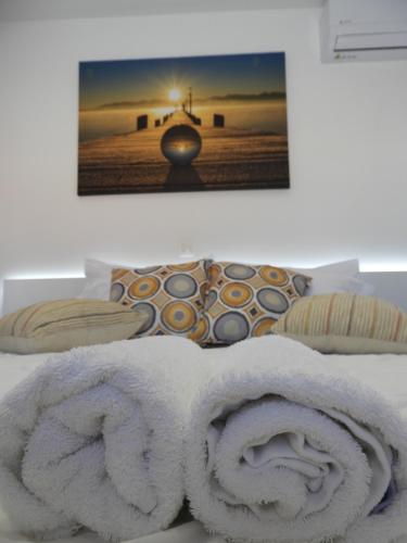 a white towel sitting on top of a bed at Angelica Residence in Gennadi