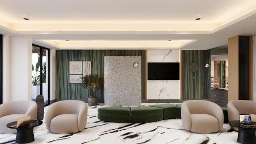 a living room with a green couch and chairs at Hotel Poem - Roof Top Pool & Panoramic Sea View in Eforie Nord